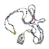 A sterling silver fish-shaped pendant with a large irregular pearl, 18ct yellow gold, cabochon moonstone and faceted natural tourmaline beads, with a length of 104cm.